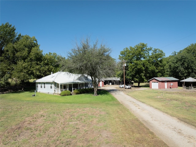 4525 Midway Rd, Weatherford, TX 76085 - view of front of house featuring driveway, a front lawn, a garage, and an outdoor structure