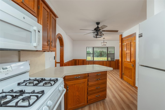 4525 Midway Rd, Weatherford, TX 76085 - kitchen featuring white appliances, light wood-style floors, a peninsula, light countertops, and brown cabinetry