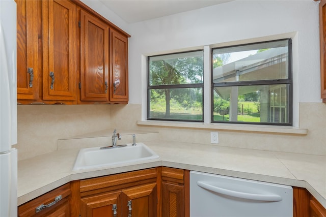 4525 Midway Rd, Weatherford, TX 76085 - kitchen featuring white appliances, light countertops, and brown cabinets