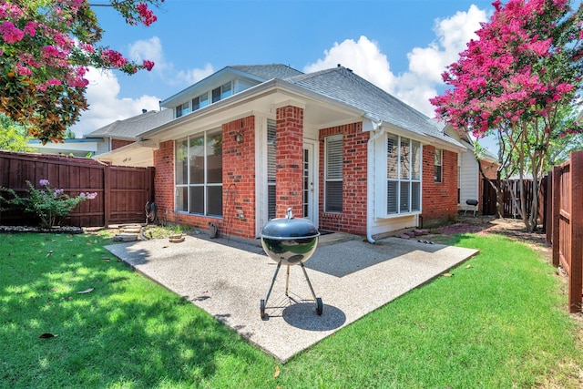 2400 Havard Oak Dr, Plano, TX 75074 - back of house with brick siding, a patio area, roof with shingles, and a fenced backyard