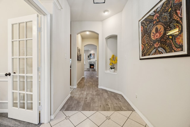 3341 Woodglen Dr, Mckinney, TX 75071 - corridor featuring arched walkways and light wood finished floors