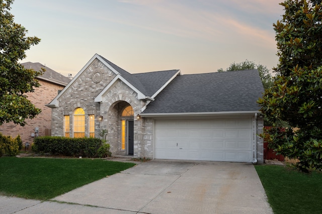 3341 Woodglen Dr, Mckinney, TX 75071 - view of front of property featuring brick siding, an attached garage, driveway, roof with shingles, and a front lawn