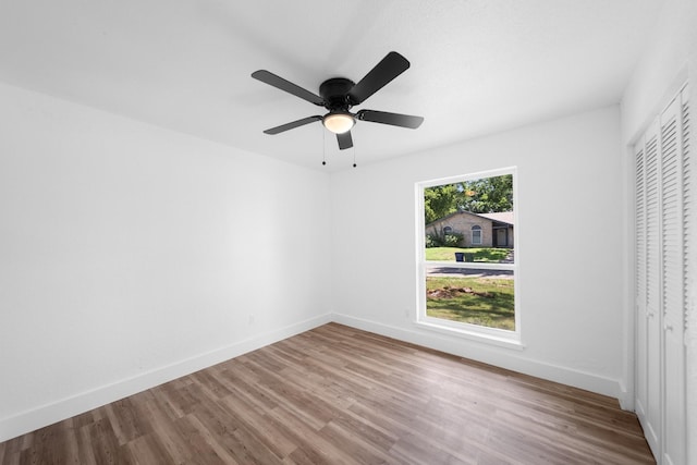 1214 Cove Dr, Garland, TX 75040 - unfurnished bedroom with wood finished floors, a closet, and ceiling fan