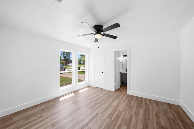 1214 Cove Dr, Garland, TX 75040 - unfurnished bedroom featuring wood finished floors, ceiling fan, and connected bathroom