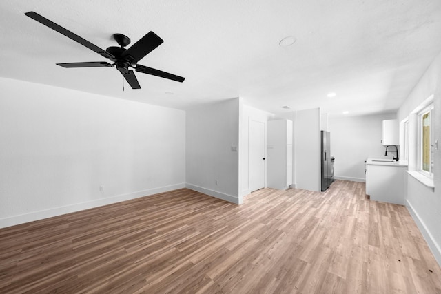 1214 Cove Dr, Garland, TX 75040 - unfurnished living room with light wood-type flooring and ceiling fan