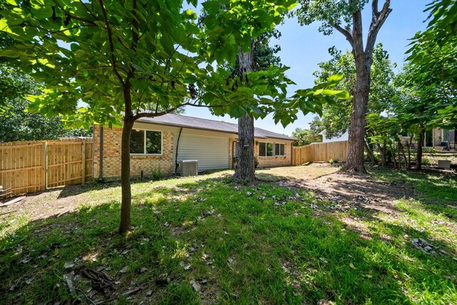 1214 Cove Dr, Garland, TX 75040 - rear view of property featuring brick siding and a fenced backyard