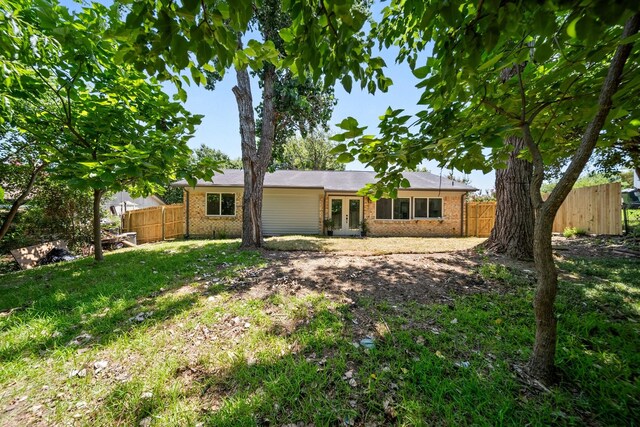 1214 Cove Dr, Garland, TX 75040 - back of property with brick siding and french doors