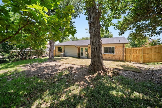 1214 Cove Dr, Garland, TX 75040 - back of property featuring brick siding and french doors