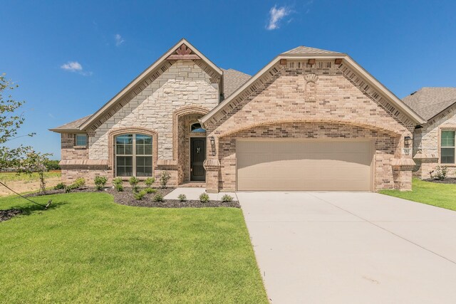 213 Navajo Trl, Alvarado, TX 76009 - french provincial home featuring an attached garage, brick siding, driveway, and a front lawn