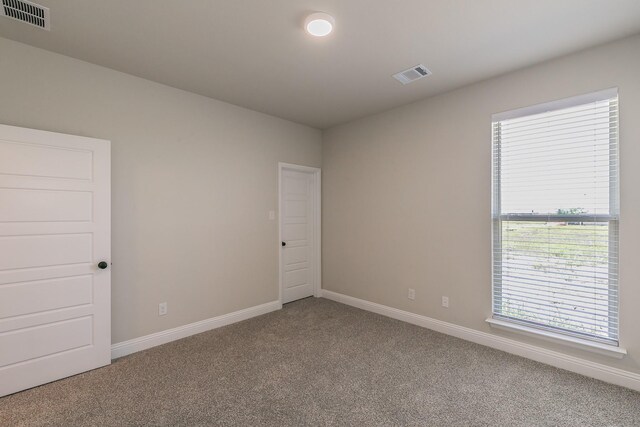 213 Navajo Trl, Alvarado, TX 76009 - carpeted empty room with baseboards