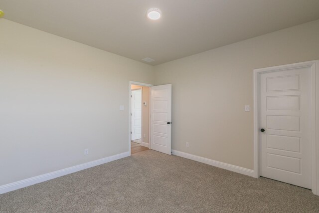 213 Navajo Trl, Alvarado, TX 76009 - unfurnished bedroom with light carpet and baseboards