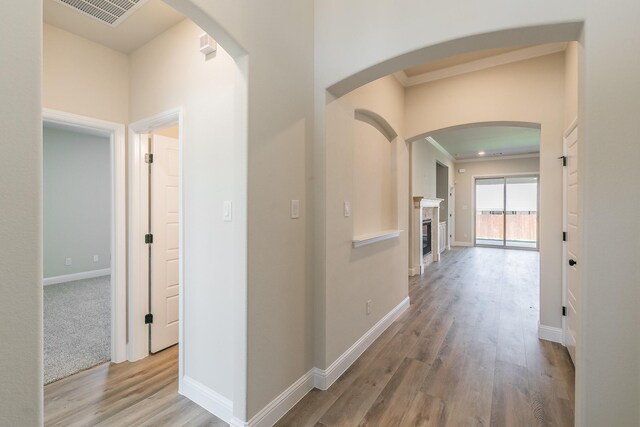 213 Navajo Trl, Alvarado, TX 76009 - hall featuring wood finished floors, arched walkways, and crown molding