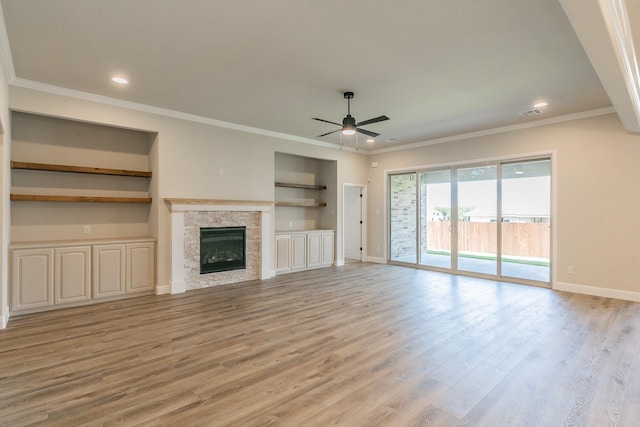 213 Navajo Trl, Alvarado, TX 76009 - unfurnished living room featuring ceiling fan, light wood finished floors, ornamental molding, a glass covered fireplace, and recessed lighting