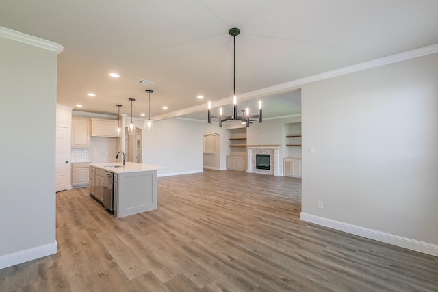 213 Navajo Trl, Alvarado, TX 76009 - kitchen with open floor plan, crown molding, recessed lighting, light countertops, and light wood-style floors