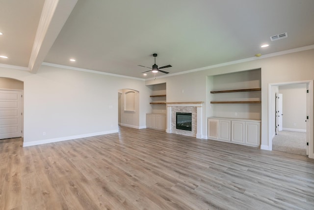 213 Navajo Trl, Alvarado, TX 76009 - unfurnished living room with arched walkways, ceiling fan, ornamental molding, recessed lighting, and a glass covered fireplace