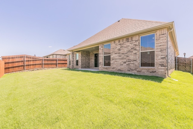 213 Navajo Trl, Alvarado, TX 76009 - back of property featuring a fenced backyard, brick siding, and roof with shingles