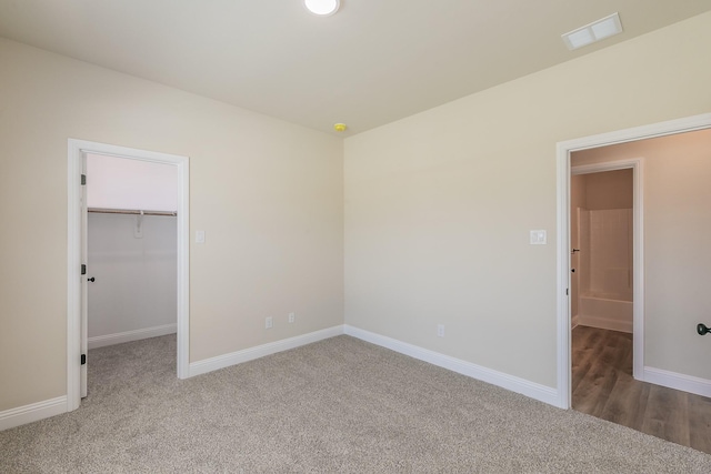 213 Navajo Trl, Alvarado, TX 76009 - unfurnished bedroom with carpet floors, a walk in closet, and a closet