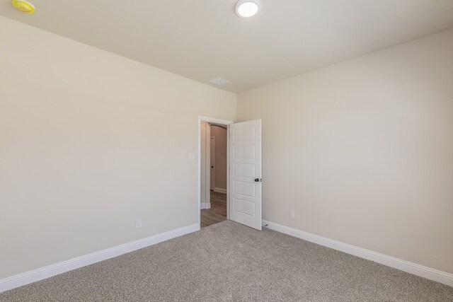 213 Navajo Trl, Alvarado, TX 76009 - unfurnished room with light colored carpet and a smoke detector