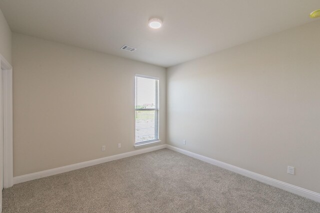 213 Navajo Trl, Alvarado, TX 76009 - carpeted spare room with baseboards and a smoke detector