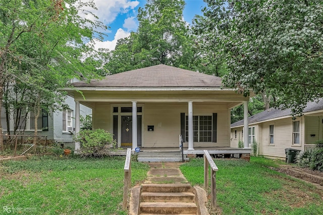 538 Dalzell St, Shreveport, LA 71104 - view of front facade featuring a porch, a front yard, a shingled roof, and cooling unit