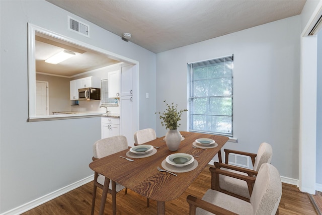 3209 Pecan Ln, Garland, TX 75041 - dining area featuring wood finished floors and baseboards