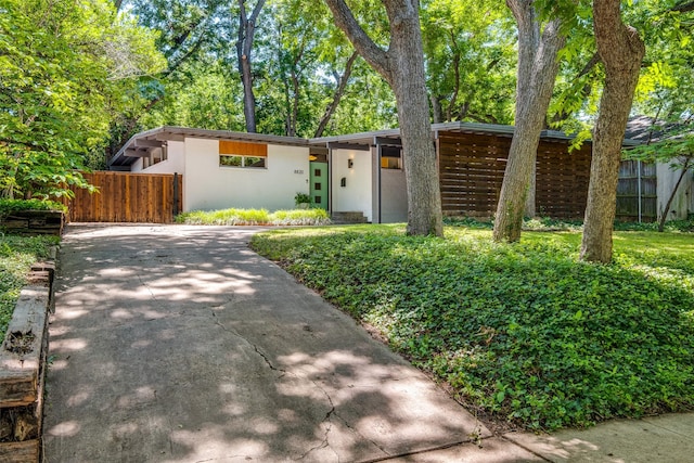 8820 Vinewood Dr, Dallas, TX 75228 - mid-century modern home featuring concrete driveway and stucco siding