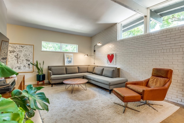 8820 Vinewood Dr, Dallas, TX 75228 - living area with brick wall and healthy amount of natural light
