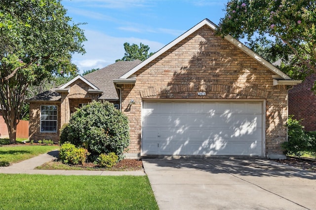 2409 Spruce Ct, Little Elm, TX 75068 - traditional-style house featuring driveway, an attached garage, brick siding, and a shingled roof