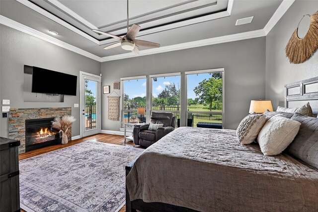 107 Bob Jones Ct, Pottsboro, TX 75076 - bedroom featuring access to exterior, a fireplace, wood finished floors, a raised ceiling, and crown molding