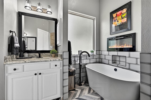 107 Bob Jones Ct, Pottsboro, TX 75076 - bathroom with a soaking tub, vanity, and a textured wall