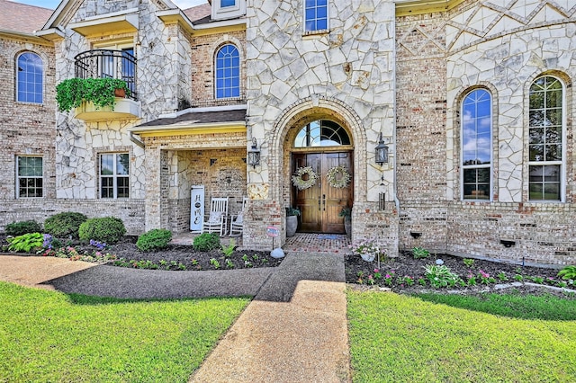 107 Bob Jones Ct, Pottsboro, TX 75076 - entrance to property with a balcony, stone siding, a lawn, and brick siding