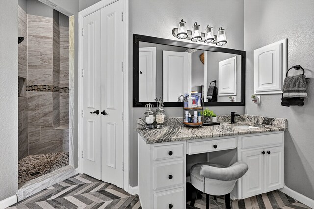 107 Bob Jones Ct, Pottsboro, TX 75076 - bathroom with a tile shower, vanity, a closet, and a textured wall