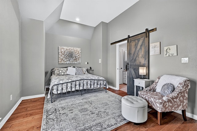 107 Bob Jones Ct, Pottsboro, TX 75076 - bedroom featuring a barn door, wood finished floors, and lofted ceiling