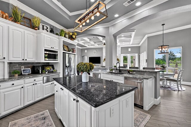 107 Bob Jones Ct, Pottsboro, TX 75076 - kitchen featuring stainless steel appliances, a warming drawer, crown molding, a kitchen island, and white cabinets