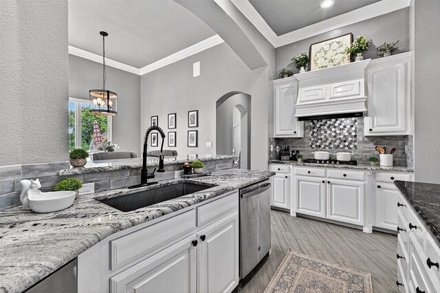 107 Bob Jones Ct, Pottsboro, TX 75076 - kitchen featuring stainless steel dishwasher, arched walkways, ornamental molding, light wood-type flooring, and white cabinets