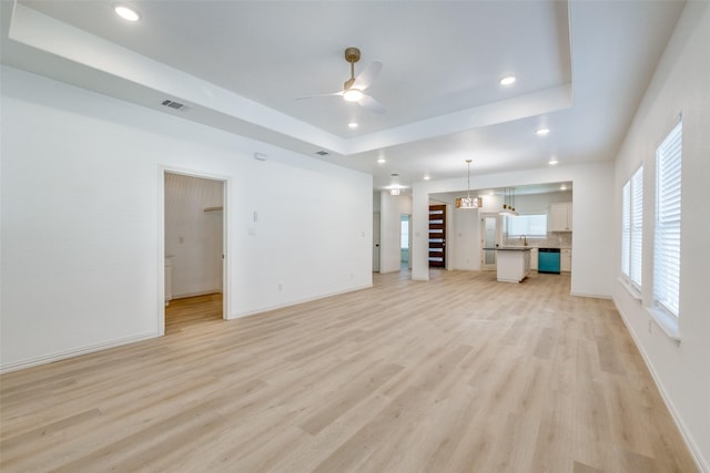 1328 Glasgow Rd, Fort Worth, TX 76134 - unfurnished living room with a ceiling fan, light wood-style floors, a tray ceiling, and recessed lighting