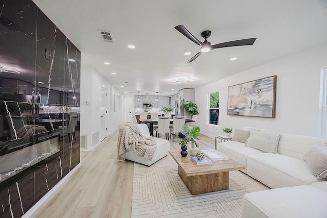 2504 Guilford Rd, Fort Worth, TX 76107 - living area featuring light wood-type flooring, ceiling fan, and recessed lighting