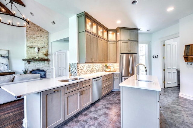 800 Manor Dr, Argyle, TX 76226 - kitchen with stainless steel appliances, open floor plan, vaulted ceiling, light countertops, and tasteful backsplash
