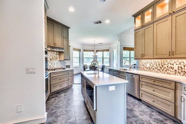 800 Manor Dr, Argyle, TX 76226 - kitchen with appliances with stainless steel finishes, tasteful backsplash, light countertops, an island with sink, and glass insert cabinets