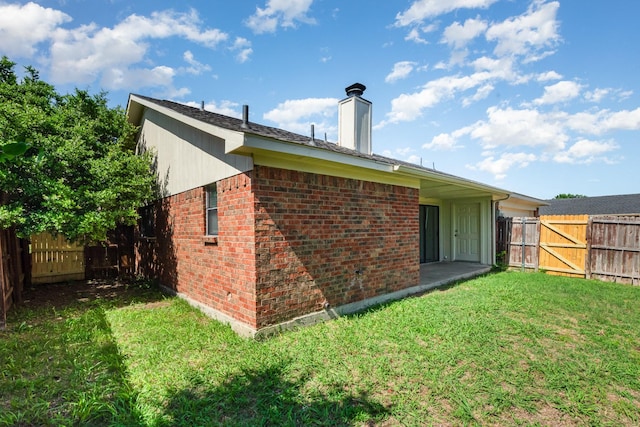 828 Whitehall Dr, Plano, TX 75023 - rear view of property with brick siding, a fenced backyard, a chimney, and a gate