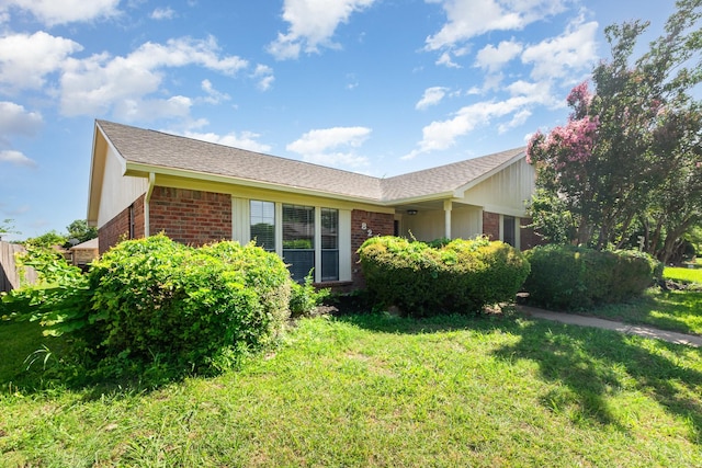 828 Whitehall Dr, Plano, TX 75023 - view of side of home with brick siding, a yard, and a shingled roof