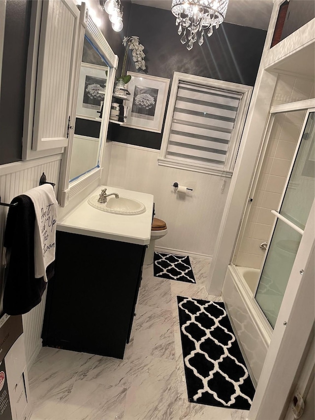 2848 Forest Ave, Fort Worth, TX 76112 - bathroom featuring vanity, a chandelier, marble look tile flooring, enclosed tub / shower combo, and a wainscoted wall