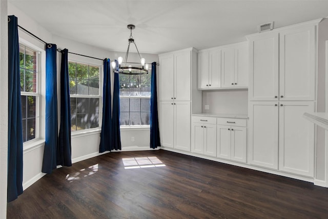 4909 Indio Ln, Sherman, TX 75092 - unfurnished dining area with a chandelier and dark wood finished floors