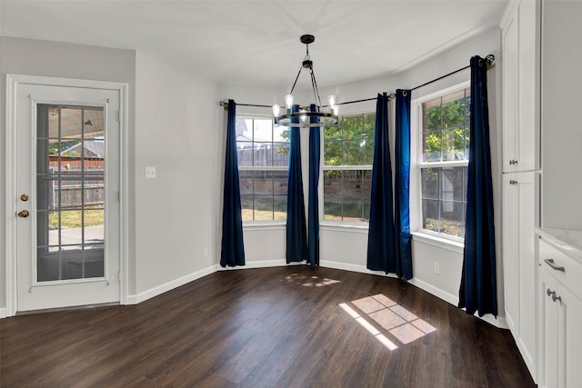 4909 Indio Ln, Sherman, TX 75092 - unfurnished dining area featuring a chandelier, dark wood-style flooring, and healthy amount of natural light