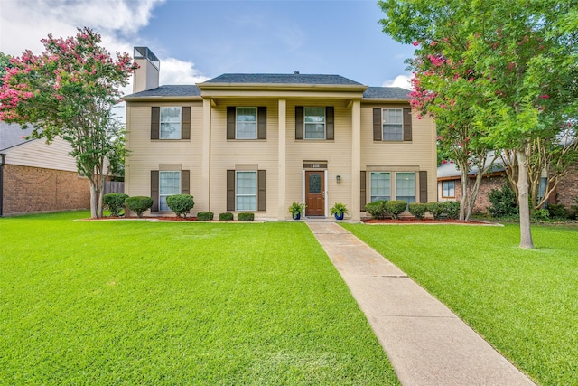 1105 Pyramid Dr, Garland, TX 75040 - view of front of home with a front lawn and a chimney