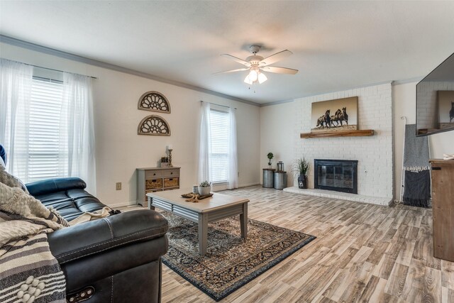 1105 Pyramid Dr, Garland, TX 75040 - living room with a ceiling fan, wood finished floors, a fireplace, and crown molding
