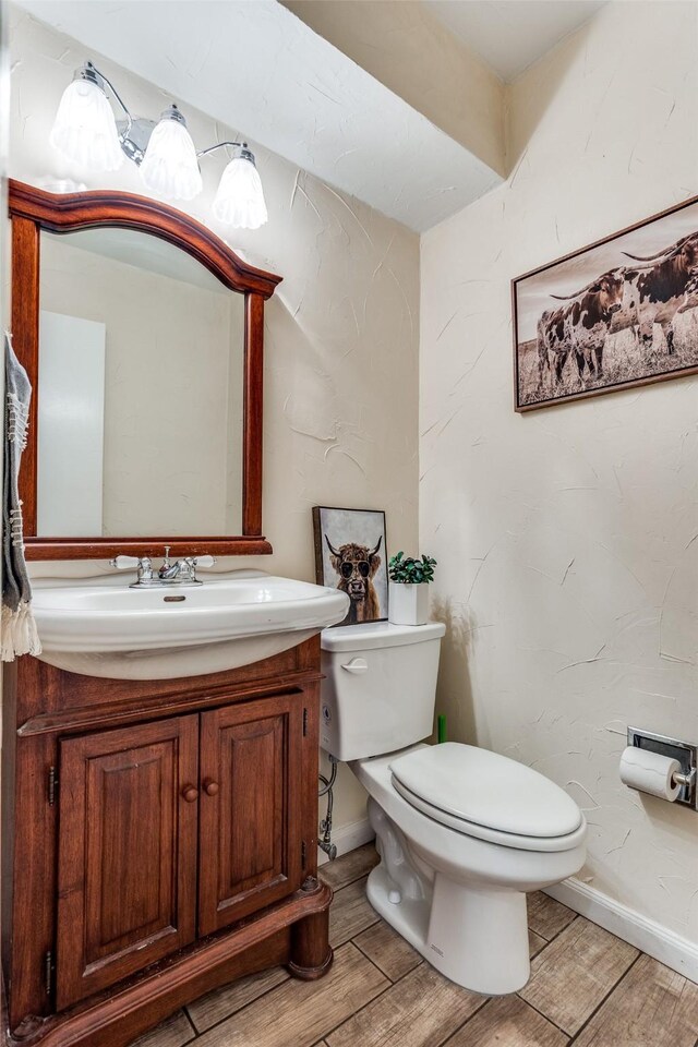 1105 Pyramid Dr, Garland, TX 75040 - half bathroom with wood finished floors and vanity
