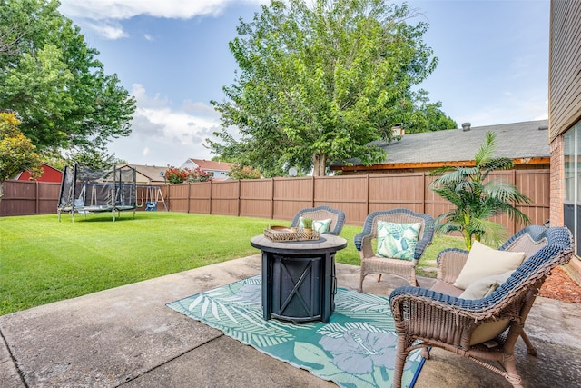 1105 Pyramid Dr, Garland, TX 75040 - fenced backyard with a trampoline, a patio area, and an outdoor fire pit