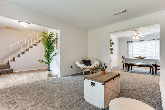 1105 Pyramid Dr, Garland, TX 75040 - carpeted living room with stairs, ornamental molding, and a ceiling fan