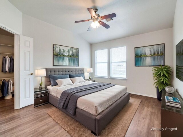 131 Freedom Trl, Forney, TX 75126 - bedroom featuring a walk in closet, a closet, light wood finished floors, lofted ceiling, and a ceiling fan